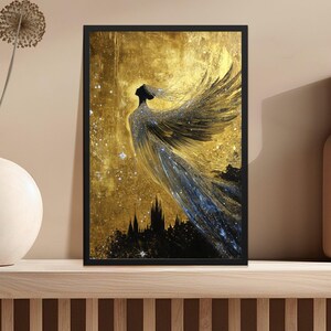May include: A black and gold framed print of a woman with wings, standing in front of a city skyline. The background is a golden color with a starry night sky.