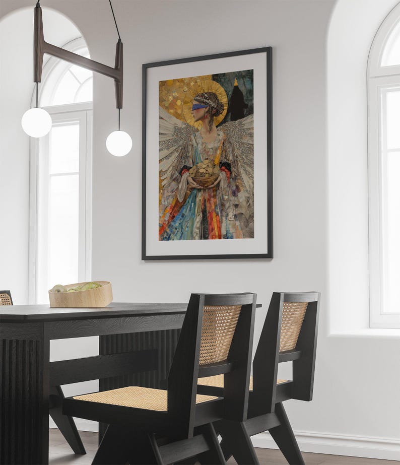 May include: A framed collage artwork featuring a woman with a blindfold, holding a basket of fruit. The artwork is set against a white wall with a black dining table and chairs in the foreground.