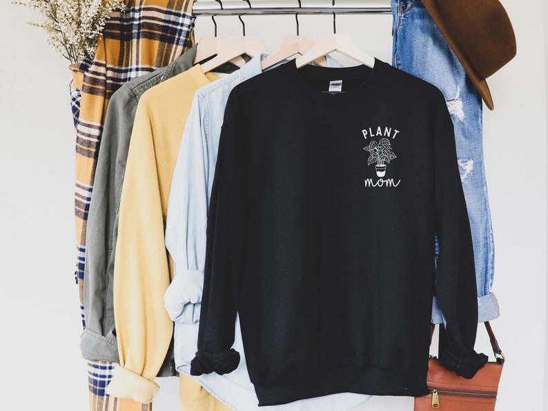 May include: Black sweatshirt with a white graphic of a potted plant and the text "PLANT MOM".
