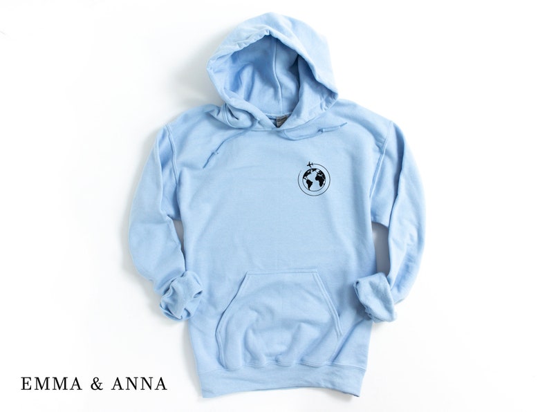 May include: A light blue hoodie with a small black graphic of the earth with airplanes flying around it.
