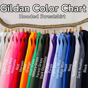 May include: Gildan Colour Chart for Hooded Sweatshirts. The chart displays 18 different colours of sweatshirts, including white, ash, sand, light pink, safety pink, heliconia, red, maroon, gold, orange, Irish green, military green, forest green, dark chocolate, orchid, purple, light blue, Carolina blue, indigo blue, royal, navy, sport grey, dark heather, and black.
