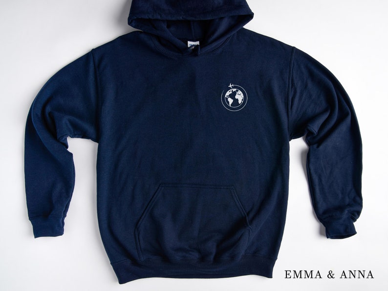 May include: A navy blue hoodie with a white globe and airplane graphic on the left chest. The hoodie has a kangaroo pocket and a drawstring hood.