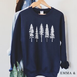 May include: A navy blue sweatshirt with a white graphic of five pine trees. The sweatshirt has a crew neck and long sleeves.