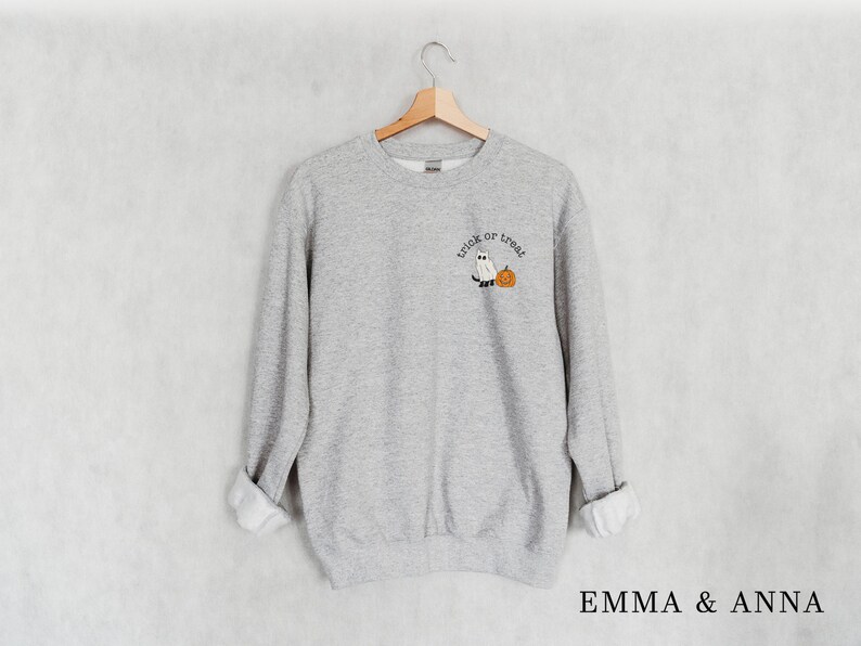 May include: A gray sweatshirt with the text "trick or treat" and a ghost and pumpkin graphic.