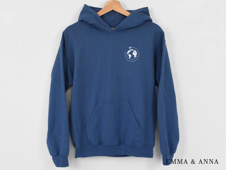May include: A blue hooded sweatshirt with a white graphic of a globe with a plane flying over it.