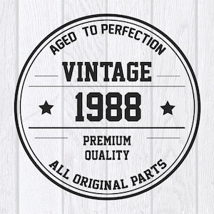 May include: A black and white circular design with the words "AGED TO PERFECTION" and "VINTAGE 1988". The design also includes the words "PREMIUM QUALITY" and "ALL ORIGINAL PARTS". Two stars are on either side of the year.