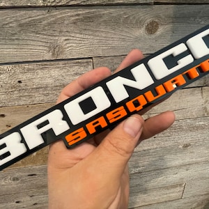 NEW &quot;SASQUATCH&quot; Throwback Fender Badges, White Upper letters and Orange Lower letters on black background.
