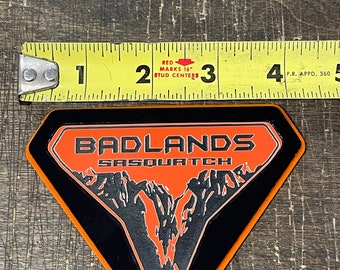 Add Some SasSquatch Attitude To Your Ride With This 2.36-inch Zinc Alloy Fender Emblem. Sticks On Easy, Looks Tough. Fits Any Truck, SUV, Or Car.