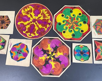 May include: A collection of colorful, abstract geometric art pieces. The artwork features various shapes, including circles, octagons, and squares, with intricate designs in shades of yellow, purple, green, orange, and brown. Each piece is unique.