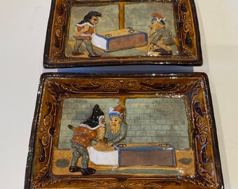 Pair of Willem Schiller and Sons majolica plaques - gnomes with matchbox c1890.