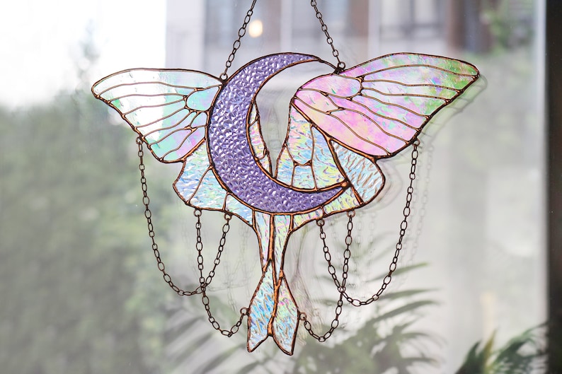 May include: A stained glass moon and butterfly suncatcher with iridescent glass and a copper chain.