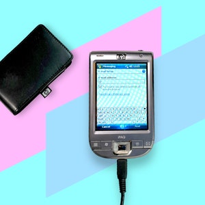May include: A silver HP iPAQ PDA with a touchscreen showing an email setup interface, connected to a black charging cable. A black leather wallet with an HP logo is to the left. The background is divided into pink and blue sections.