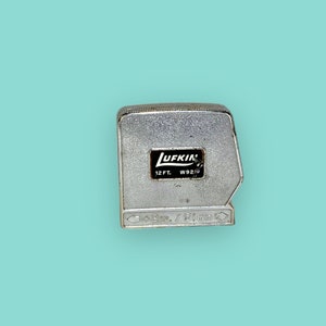 Vintage Metal Tape Measure tool.