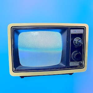 May include: A retro television with a cream-coloured frame and a black screen showing static. The control panel has knobs and dials. The TV is set against a blue gradient background.