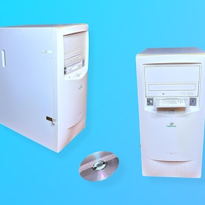 May include: Two white Gateway desktop computer towers with CD-ROM drives and a silver CD on a blue background. The towers have a simple design with a Gateway logo. The CD is reflective.