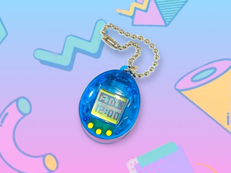 May include: A blue handheld digital pet game with a silver chain. The screen displays the time as 6:30 and 12:00. The game has three yellow buttons below the screen. The background is a gradient of blue and purple with geometric shapes.