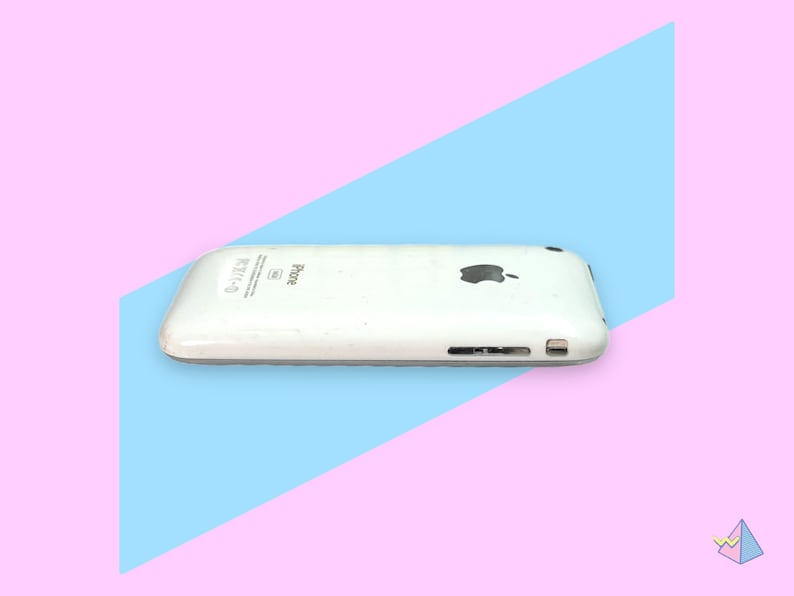 May include: A white iPhone with the Apple logo on the back. The phone has a silver trim and a speaker and charging port on the bottom. The phone is set against a pink and blue background.