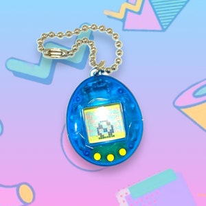 May include: A blue, egg-shaped virtual pet toy with a small screen displaying a pixelated character. The toy has three yellow buttons and a silver chain for attachment. The background features a colorful, geometric design.