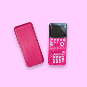 Puede incluir: Una calculadora gráfica TI-84 Plus CE de color rosa intenso con su funda protectora rosa a juego. La calculadora tiene una pantalla negra y un teclado completo con varias teclas de función. La funda está abierta y colocada junto a la calculadora sobre un fondo rosa claro.