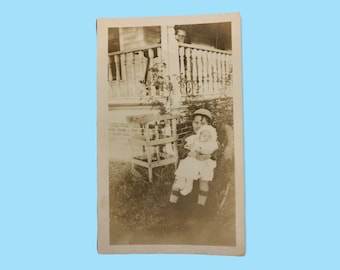 Vintage photo of little boy holding a baby