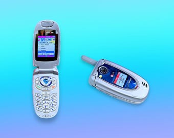 May include: Two silver flip phones on a blue gradient background. One phone is open, displaying a menu with options like "Voice Phone" and "Tools." The other phone is closed, showing a screen that says "Searching for Service."