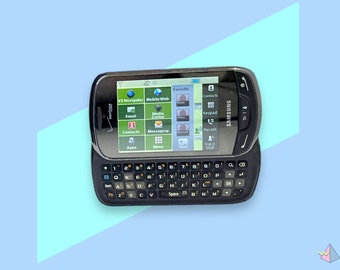 Teléfono celular Samsung vintage con pantalla táctil y teclado. Funciona.