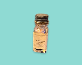 Botella de vidrio antigua de boticario con gotas para el dolor de muelas. Rara.