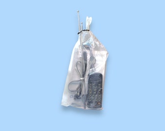 May include: A clear plastic bag containing a black remote control, a long antenna, and paperwork. The items are tied together with a black zip tie against a light blue background.