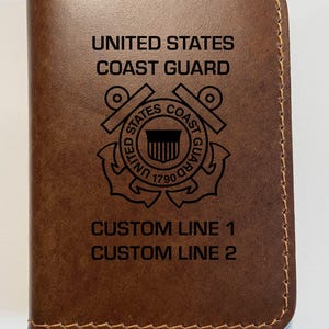 May include: Brown leather wallet with the United States Coast Guard emblem and the text "UNITED STATES COAST GUARD" and "CUSTOM LINE 1 CUSTOM LINE 2".