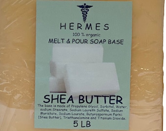 May include: A 5-pound block of shea butter melt and pour soap base, wrapped in clear plastic. The label reads "HERMES 100% organic MELT & POUR SOAP BASE SHEA BUTTER The base is made of Propylene Glycol, Sorbitol, Water, sodium Stearate, Sodium Laureth Sulfate, Sodium Myristate, Sodium Laurate, Butyrospermum Parkii (Shea Butter), Triethanolamine and Titanium Dioxide. 5 LB"
