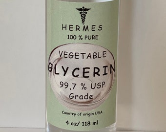 May include: A clear glass bottle with a white cap, containing a clear liquid. The label reads "HERMES 100% PURE VEGETABLE GLYCERIN 99.7% USP Grade Country of origin USA 4 oz/ 118 ml".
