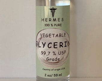 May include: A clear glass bottle with a white cap, containing vegetable glycerin. The label is green and white and reads "HERMES 100% PURE VEGETABLE GLYCERIN 99.7% USP Grade Country of origin USA 2 oz/ 59 ml".