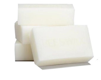 May include: A stack of four white rectangular bars of soap.