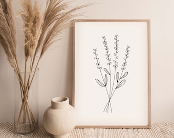 May include: A framed art print featuring a minimalist black line drawing of lavender sprigs on an off-white background. The artwork is displayed in a light brown wooden frame. A vase with dried pampas grass and a small beige vase are in the background.