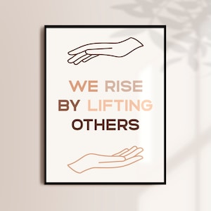 May include: A white poster with black text and brown line drawings of hands. The text reads "We Rise By Lifting Others".