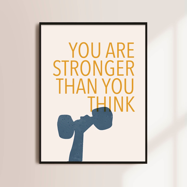 May include: A motivational poster with a peach background and a blue silhouette of a person lifting a dumbbell. The text "YOU ARE STRONGER THAN YOU THINK" is in yellow.