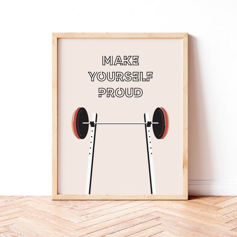 May include: A motivational poster with a barbell on a squat rack and the text "MAKE YOURSELF PROUD" in black letters on a light pink background.