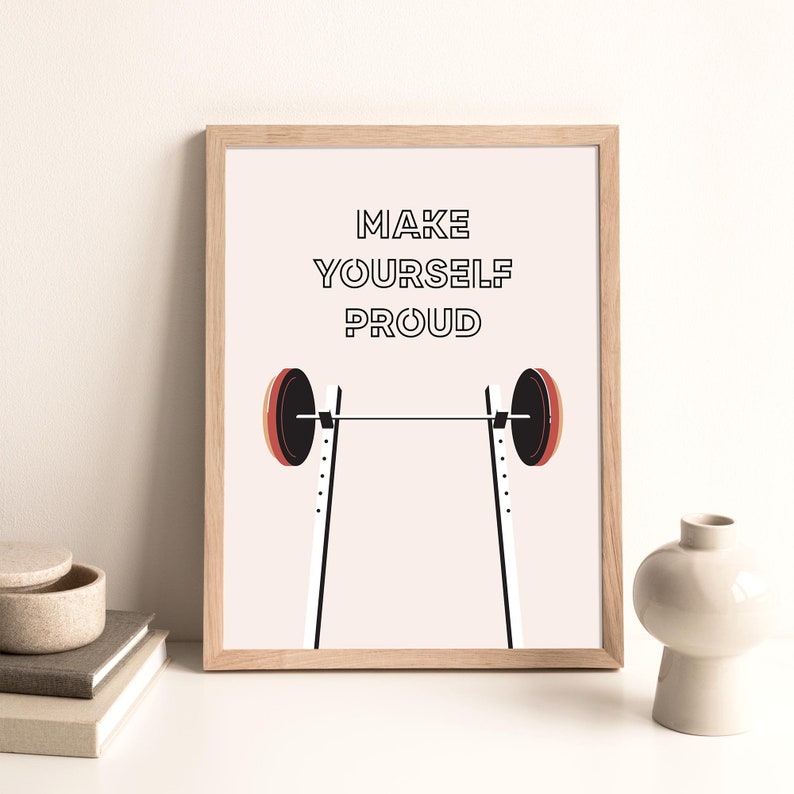 May include: A motivational poster with a barbell and the text "MAKE YOURSELF PROUD" in black text on a light pink background.