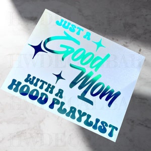May include: A turquoise and blue iridescent vinyl sticker with the text "Just a Good Mom with a Hood Playlist".