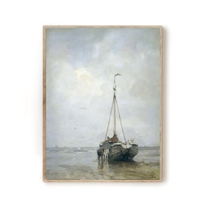 May include: A painting of a wooden sailboat on a beach with a cloudy sky. The boat is partially submerged in the water and there are people on board. The painting is framed in a light wood frame.