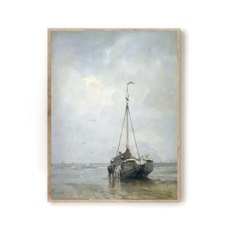 May include: A painting of a wooden sailboat on a beach with a cloudy sky. The boat is partially submerged in the water and there are people on board. The painting is framed in a light wood frame.
