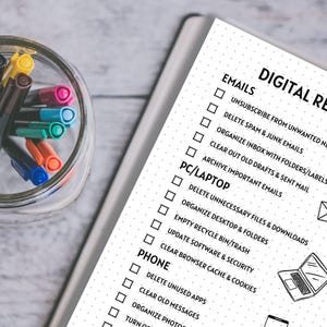 May include: A black and white checklist with the title "Digital Reset" and categories for emails, PC/Laptop, and phone. Each category has a list of tasks to complete, such as unsubscribing from unwanted newsletters, deleting spam emails, and organizing files.
