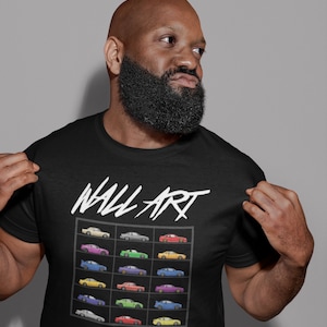 May include: A black t-shirt with the words "Wall Art" printed in white. The shirt features a graphic of a grid of colorful cars.