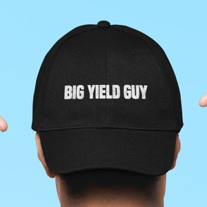 May include: A black baseball cap with the text "BIG YIELD GUY" embroidered in white on the front.