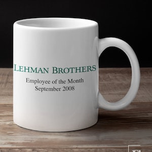 May include: White ceramic mug with a green inscription that reads "Lehman Brothers Employee of the Month September 2008".