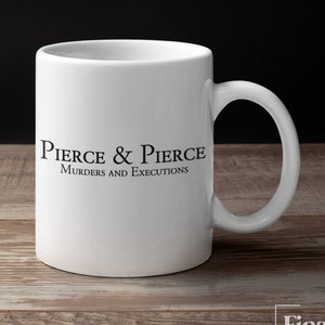 May include: White ceramic coffee mug with a black logo that reads "Pierce & Pierce, Murders and Executions".