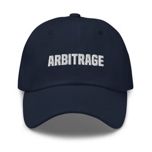 May include: A navy blue baseball cap with the word "ARBITRAGE" embroidered in white on the front.