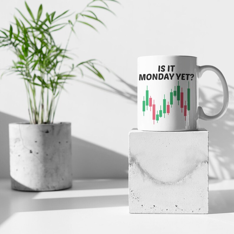 May include: White ceramic mug with a black and green graphic of a stock market chart and the text "Is it Monday yet?"