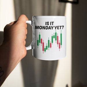 May include: White ceramic mug with a black and green stock chart graphic and the text "Is it Monday yet?" printed on it.