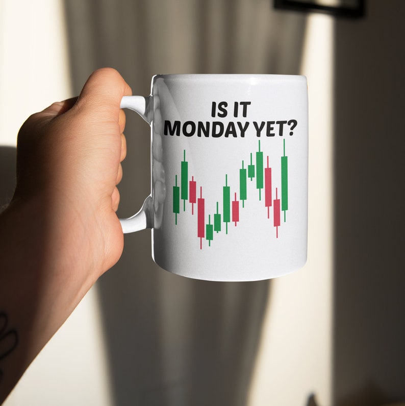 May include: White ceramic mug with a black and green stock chart graphic and the text "Is it Monday yet?" printed on it.